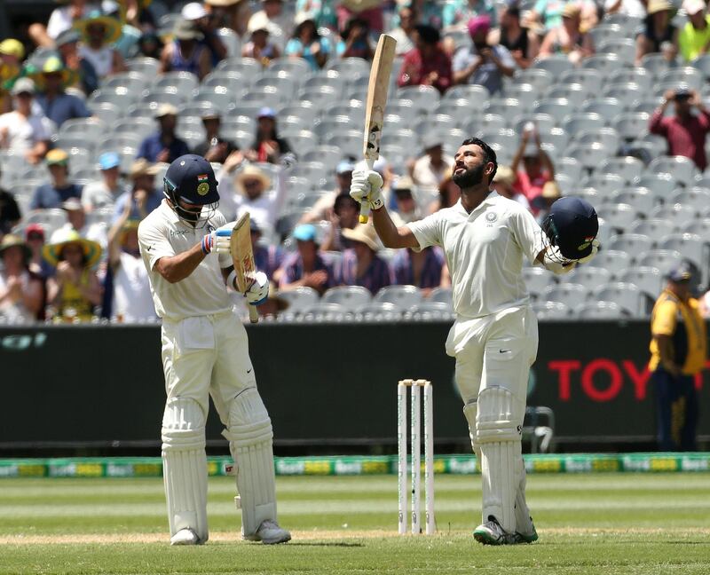 India's Cheteshwar Pujara (R) celebrates his century with captain Virat Kohli applauding on day two of the third test match between Australia and India at the MCG in Melbourne, Australia, December 27, 2018. AAP/Hamish Blairvia REUTERS  ATTENTION EDITORS - THIS IMAGE WAS PROVIDED BY A THIRD PARTY. NO RESALES. NO ARCHIVE. AUSTRALIA OUT. NEW ZEALAND OUT.