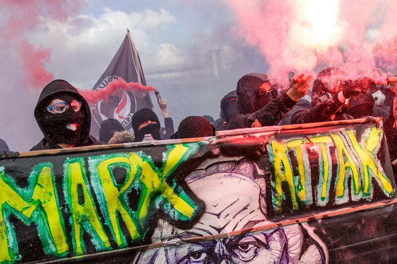 Masked protesters block a road ahead of clashes with French police. EPA/CHRISTOPHE PETIT TESSON