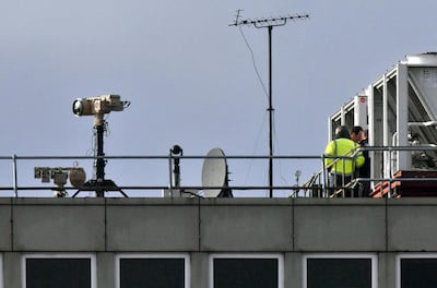 Counter drone equipment is deployed on a rooftop at Gatwick airport in Gatwick, England, Friday, Dec. 21, 2018. Flights resumed at London's Gatwick Airport on Friday after drones sparked about 36 hours of travel chaos including the shutdown of the airfield, leaving tens of thousands of passengers stranded or delayed during the busy holiday season. (John Stillwell/PA via AP)