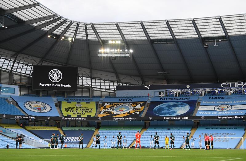 Manchester City and Burnley players observe a minute's silence before the match for the victims of the coronavirus disease.