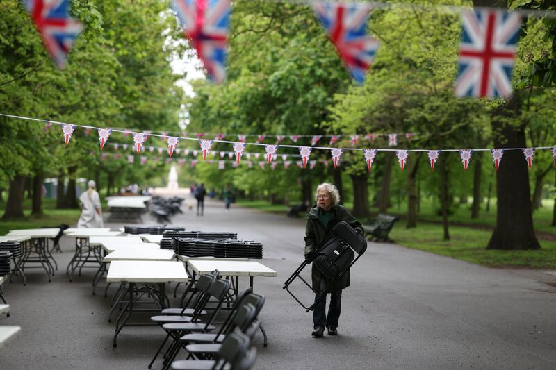 A volunteer sets up tables and chairs for the Big Lunch in Regent’s Park. Getty Images