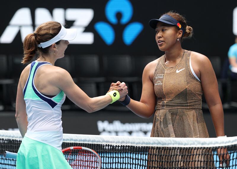 Naomi Osaka and Alize Cornet greet each other at the net after their match. Reuters