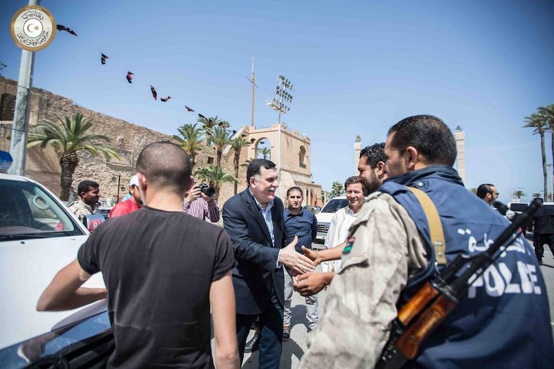Fayez Serraj, prime minister of Libya’s UN-backed unity government, greets people on a street in Tripoli. AFP / Libya’s Prime Minister Facebook Page / March 30, 2016