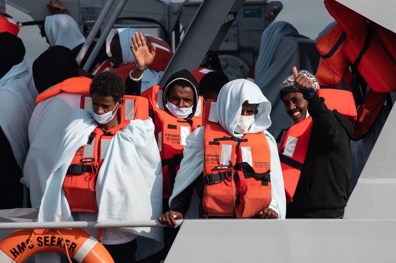 The possibility of transferring asylum seekers to the remote islands was eventually shelved. Migrants wave and give a thumbs up on board HMC Seeker. Getty Images