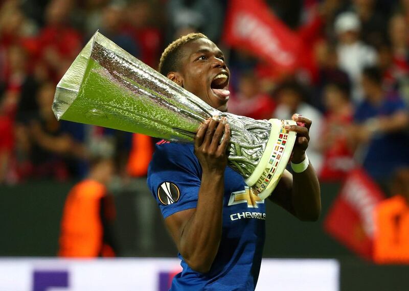 Paul Pogba celebrates with the Europa League trophy after helping Manchester United to victory over Ajax. Michael Dalder / Reuters