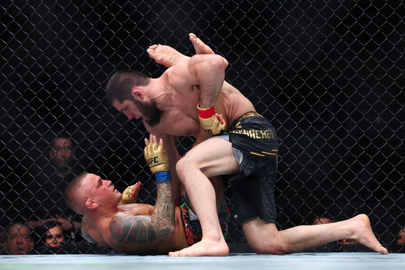 Islam Makhachev and Dustin Poirier grapple during their lightweight title bout at UFC 302. AFP