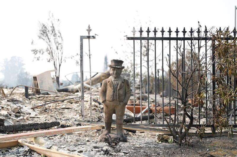 A statue stands amongst a home destroyed by the Tubbs Fire in Santa Rosa, California. Stephen Lam / Reuters