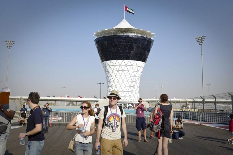 Attendees of the Etihad Airways Abu Dhabi Grand Prix walk in the Pit Lane area. Razan Alzayani / The National