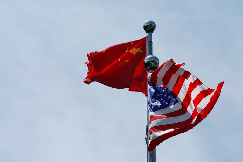FILE PHOTO: Chinese and U.S. flags flutter near the Bund in Shanghai, China July 30, 2019.  REUTERS/Aly Song/File Photo