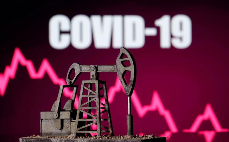 FILE PHOTO: A 3D printed oil pump jack is seen in front of displayed stock graph and "COVID-19" words in this illustration picture, April 14, 2020. REUTERS/Dado Ruvic/Illustration/File Photo