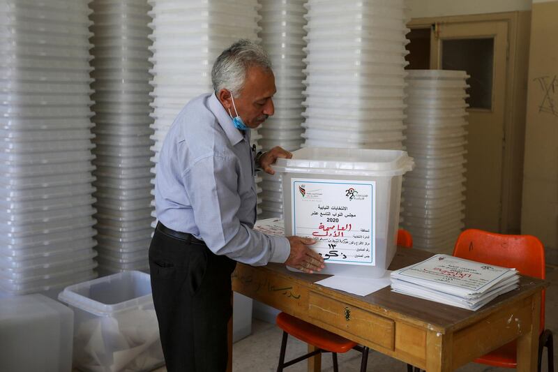 A Jordanian election official prepairs ballot boxes for the parliamentary elections which will be held on November 10, amid fears over rising number of the coronavirus disease cases, at a vote counting center in Amman. Reuters
