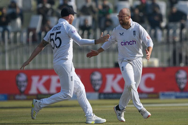 England's Jack Leach celebrates with captain Ben Stokes after taking the wicket of Pakistan batter Imam-ul-Haq for 121. AFP