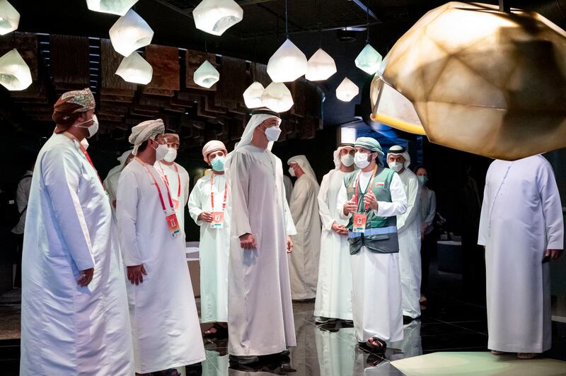 Sheikh Mohamed is shown exhibits inside the Oman Pavilion.