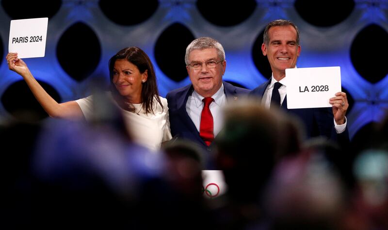 International Olympic Committee (IOC) President Thomas Bach next to Mayor of Paris Anne Hidalgo and Mayor of Los Angeles Eric Garcetti ratifies Paris 2024 and Los Angeles 2028 host cities for Olympics games during the 131st IOC session in Lima, Peru September 13, 2017. REUTERS/Mariana Bazo