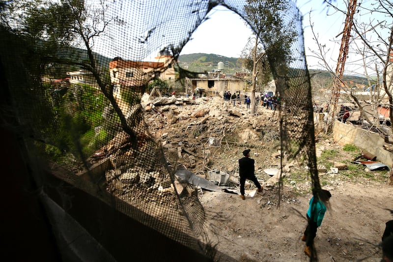 People inspect the damage at the site of an airstrike in Habbariyah, southern Lebanon, 27 March 2024.  Lebanese state media said seven medics were killed and four were injured in an Israeli airstrike early 27 March targeting the Jamaa Islamiya's emergency and relief center in the Hasbaya town of Habbariyah.  Hezbollah condemned the attack in a statement saying that this aggression 'will not pass without retaliation and punishment'.  The Israel Defense Forces (IDF) said fighter jets struck a 'military compound' in the area of Habbariyah, killing a 'significant operative' belonging to the Jamaa Islamiya 'who advanced attacks against Israel'.   EPA / STR
