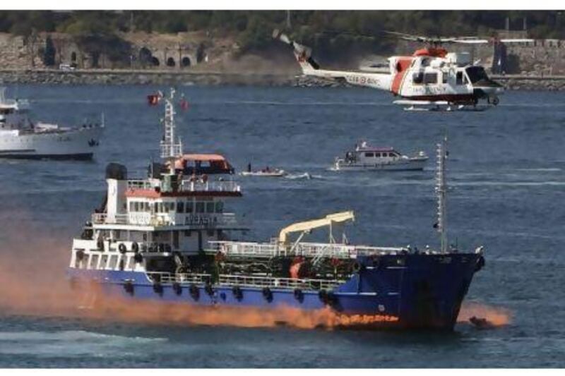 A Turkish Coast Guard helicopter flies over an oil tanker during a National marine pollution emergency response exercises in the Bosphorus yesterday. Osman Orsal / Reuters