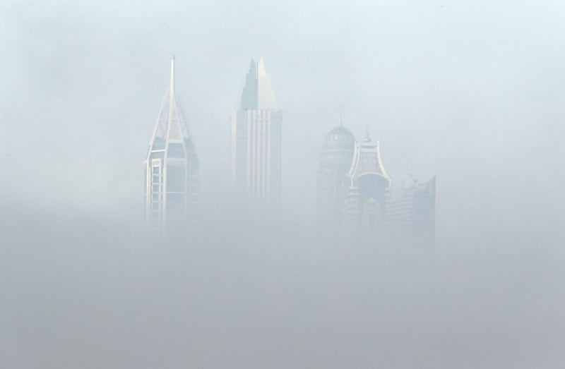 DUBAI, UNITED ARAB EMIRATES , April 08 – 2020 :- View of the towers in Dubai Media City during the early morning fog in Dubai. Dubai is conducting 24 hours sterilisation programme across all areas and communities in the Emirate and told residents to stay at home. UAE government told residents to wear face mask and gloves all the times outside the home whether they are showing symptoms of Covid-19 or not. (Pawan Singh/The National) For News/Online/Instagram/Standalone