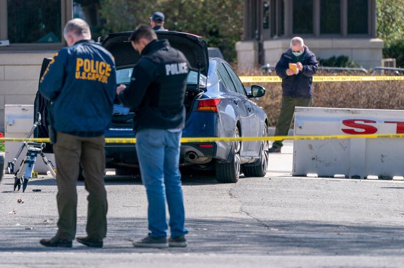 Police investigate the scene after a car crashed into a barrier on Capitol Hill, in US capital Washington. AP Photo