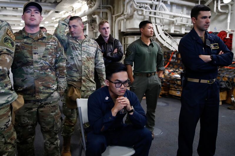 A joint Nasa and US military team watches as divers recover the Orion capsule. EPA