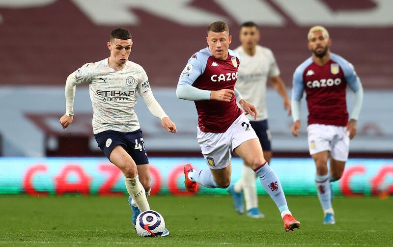BIRMINGHAM, ENGLAND - APRIL 21: Ross Barkley of Aston Villa battles for possession with Phil Foden of Manchester City  during the Premier League match between Aston Villa and Manchester City at Villa Park on April 21, 2021 in Birmingham, England. Sporting stadiums around the UK remain under strict restrictions due to the Coronavirus Pandemic as Government social distancing laws prohibit fans inside venues resulting in games being played behind closed doors.  (Photo by Michael Steele/Getty Images)