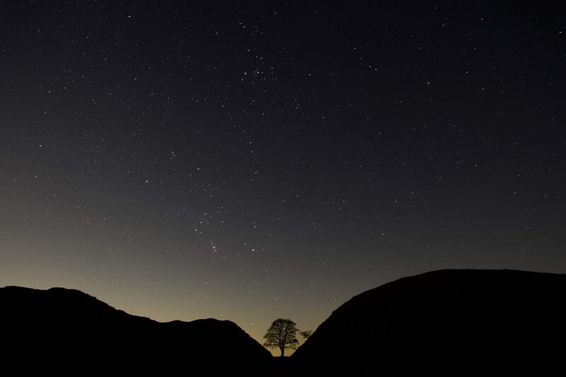Stars sparkle over a section of Hadrian's Wall, near Hexham, on Wednesday. This year marks the 1900 anniversary of the start of the construction of Hadrian's Wall, which took six years to complete and was built to guard the northern frontier of the Roman Empire in 122 AD.  AFP
