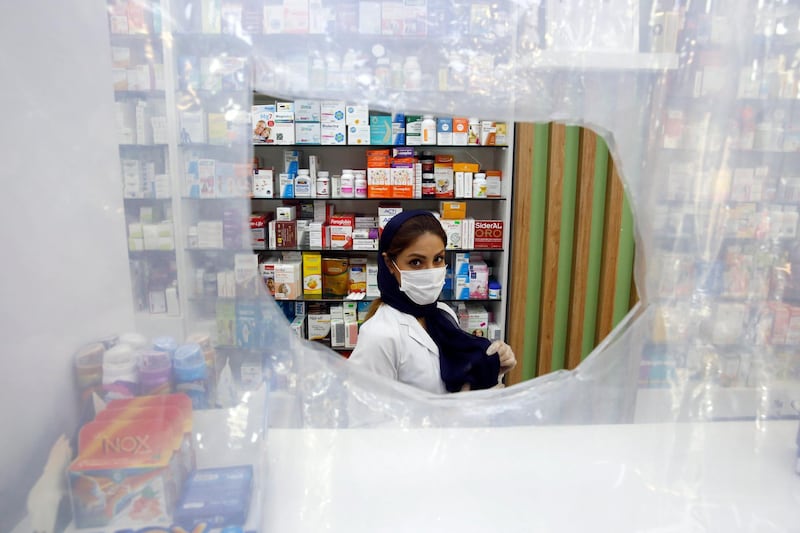 epa08556688 An Iranian doctor works at a drugstore in downtown Tehran, Iran, 20 July 2020. Media reported that Iran has been blaming US over the sanctions which even has been followed over the coronavirus (COVID-19) crisis time in the country. From imported chemo and other medicines to those made domestically, many Iranians blame shortages on US sanctions.  EPA/ABEDIN TAHERKENAREH