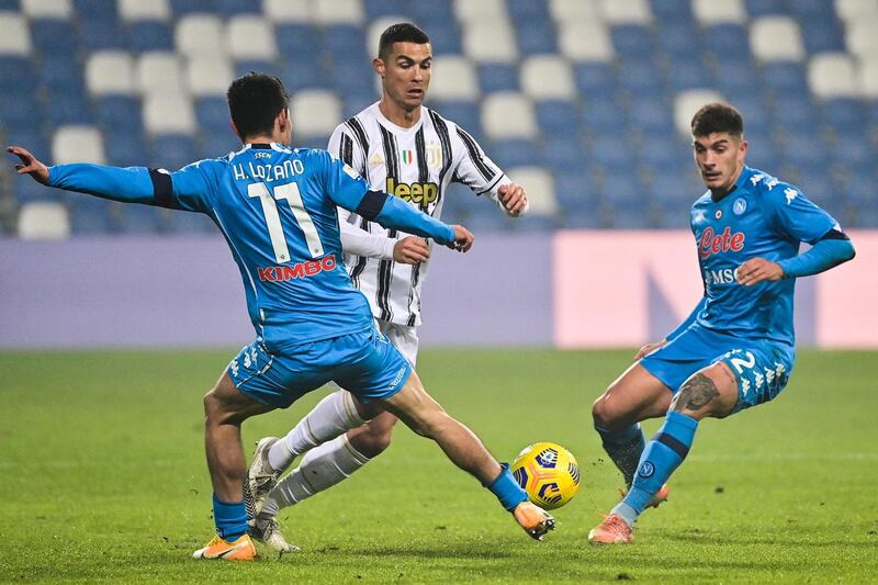 Juventus' Cristiano Ronaldo under pressure from Hirving Lozano Giovanni and Di Lorenzo of Napoli. AFP