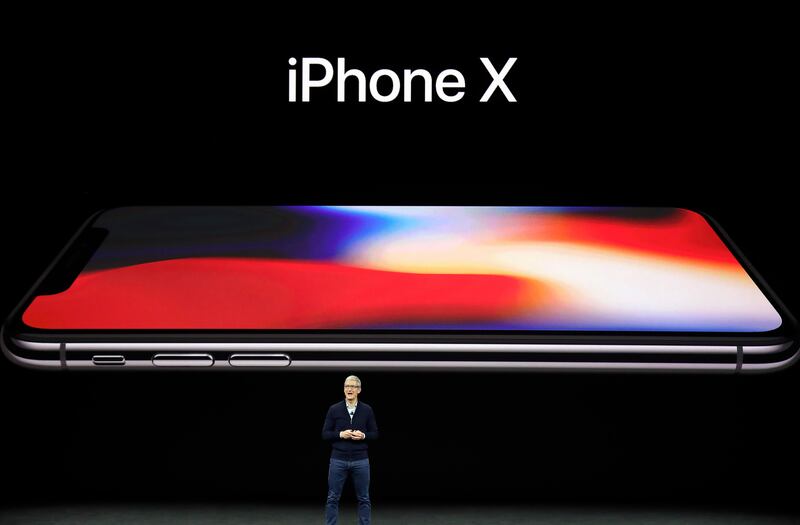 Apple CEO Tim Cook, announces the new iPhone X at the Steve Jobs Theater on the new Apple campus on Tuesday, Sept. 12, 2017, in Cupertino, Calif. (AP Photo/Marcio Jose Sanchez)