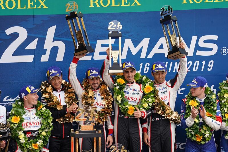epa07652043 Sebastien Buemi of Switzerland, Kazuki Nakajima of Japan and Fernando Alonso of Spain, drivers of Toyota Gazoo Racing (starting no.8) in a Toyota TS050 Hybrid celebrate on the podium after winning the Le Mans 24 Hours race in Le Mans, France, 16 June 2019.  EPA/EDDY LEMAISTRE