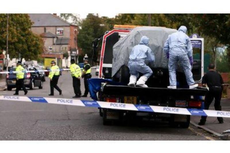 Police forensic science officers cover a car on a lowloader on Ladypool Road, near to Turner Street, Sparkbrook, Birmingham, after the arrest of six men in Birmingham as part of a large intelligence-led counter-terrorism operation.