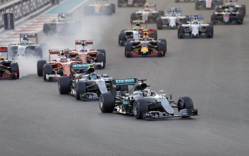 Lewis Hamilton leads Mercedes-GP teammate Nico Rosberg off the start line of the Abu Dhabi Grand Prix. Valdrin Xhemaj / EPA