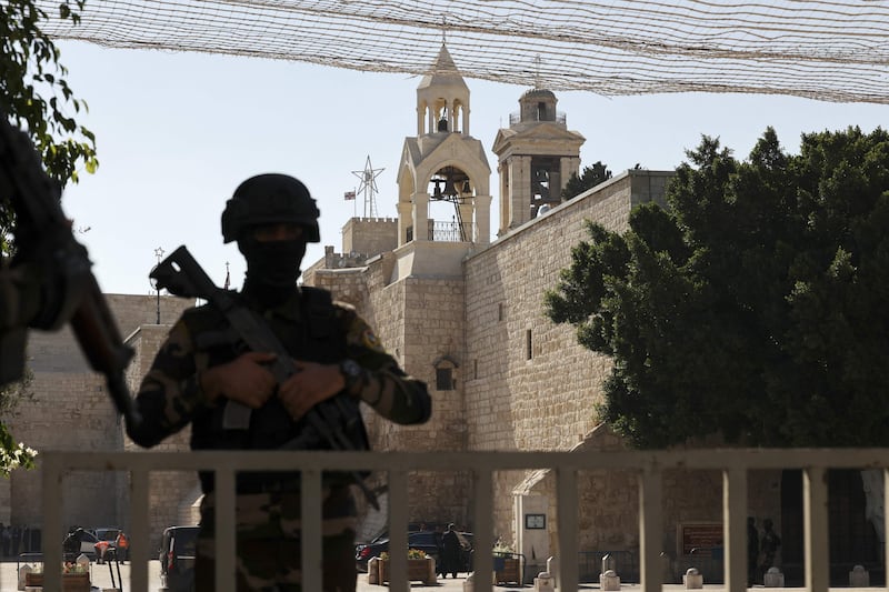 A Palestinian security officer stands guard near the Church of the Nativity in Bethlehem in the occupied West Bank before US President Joe Biden’s official visit. AFP