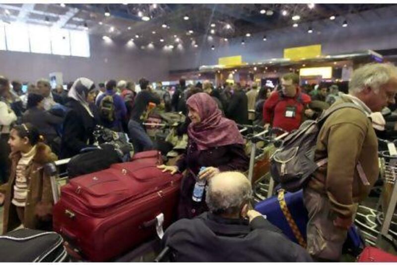 Confusion reigns at Cairo International Airport as passengers try to leave Egypt yesterday.