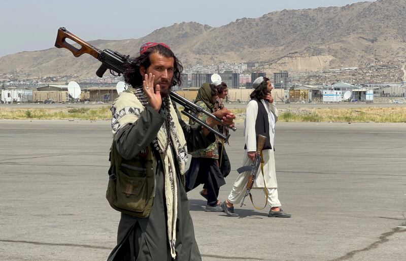 Taliban forces patrol a runway a day after US and UK troops withdrawal from Hamid Karzai International Airport in Kabul. Reuters