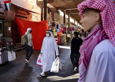 Emiratis shop at the Dubai grand market, in the Gulf city of Dubai, on January 6, 2021. (Photo by Karim SAHIB / AFP)