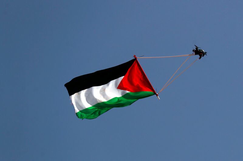 A drone carrying a Palestinian flag flies over the walls of Jerusalem's Old City during the flag march. EPA