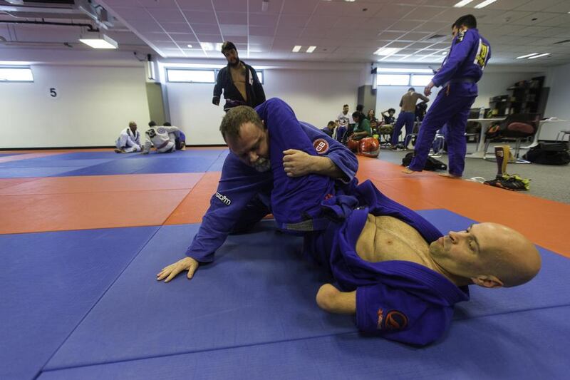Stacy Duchscherer, 50, from Canada, top, and Stuart Penn, 39, from Jersey, UK, both para-jiu jitsu players, during a practice session during the Abu Dhabi World Jiu Jitsu Festival at the Ipic Arena in Abu Dhabi on April 13, 2017. Christopher Pike / The National
