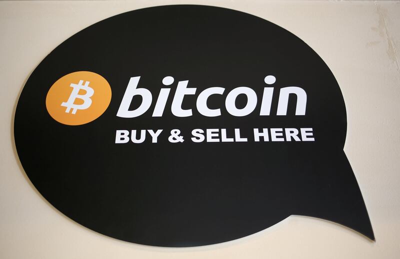 FILE PHOTO: A sign is seen in a restaurant where a Bitcoin ATM is located in Toronto, Ontario, Canada June 3, 2017.  REUTERS/Chris Helgren/File Photo