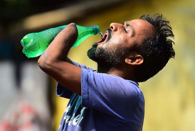 A man drinks water in Allahabad. AFP