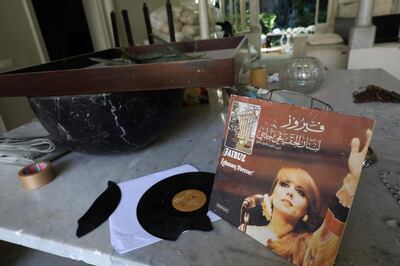 A broken record of Lebanese diva Fayrouz's war-time album "Libnan el-Haqiqi Jayi" (The True Lebanon is Coming) which was released in the late 1970s is seen in this photo taken on August 17, 2020 among other damaged items inside the home of one of Beirut's most iconic residents, world-renowned fashion designer Elie Saab, in the Lebanese capital's historic Gemmayzeh district. Saab's elegant early 20th-century home overlooking the main street of the vibrant creative hub of Gemmayzeh, like the whole area, was gutted by the massive August 4 port explosion which  authorities said was caused by huge amounts of ammonium nitrate stored at the port.
The blast disfigured huge swathes of the capital, killed 177 people and wounded at least 6,500 more. / AFP / ANWAR AMRO

