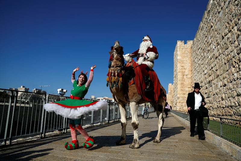 Santa Claus - real name Issa Kassissieh - swaps his traditional reindeer for a camel at Jaffa Gate in Jerusalem's Old City. Reuters