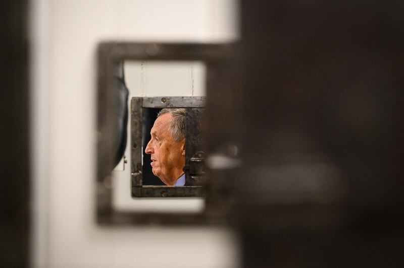 Former police inspector Philip Gough is seen through a row of cell doors at Bow Street Police Museum in London, England. The site was once a police station, where he served from 1989 until it closed in 1992. Getty