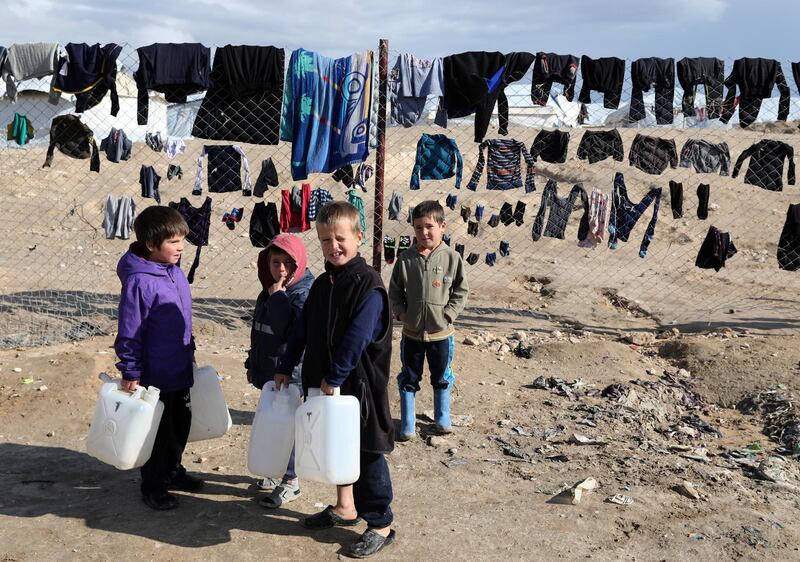 Children hold onto water containers in al-Hol camp, Syria, January 8, 2020. REUTERS/Goran Tomasevic     SEARCH "ISLAMIC STATE PRISONERS" FOR THIS STORY. SEARCH "WIDER IMAGE" FOR ALL STORIES.
