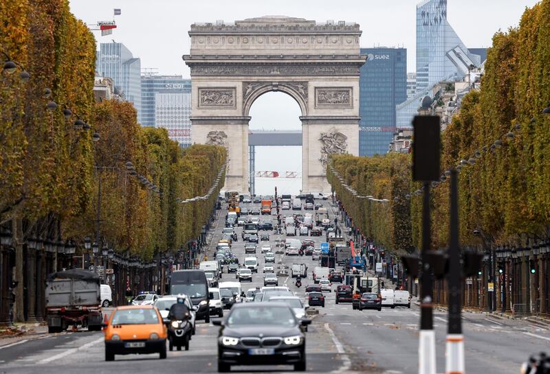 People drive their cars on the Champs-Elysee avenue in Paris, on October 30, 2020, on the first day of a second national general lockdown aimed at curbing the spread of Covid-19. (Photo by Thomas COEX / AFP)