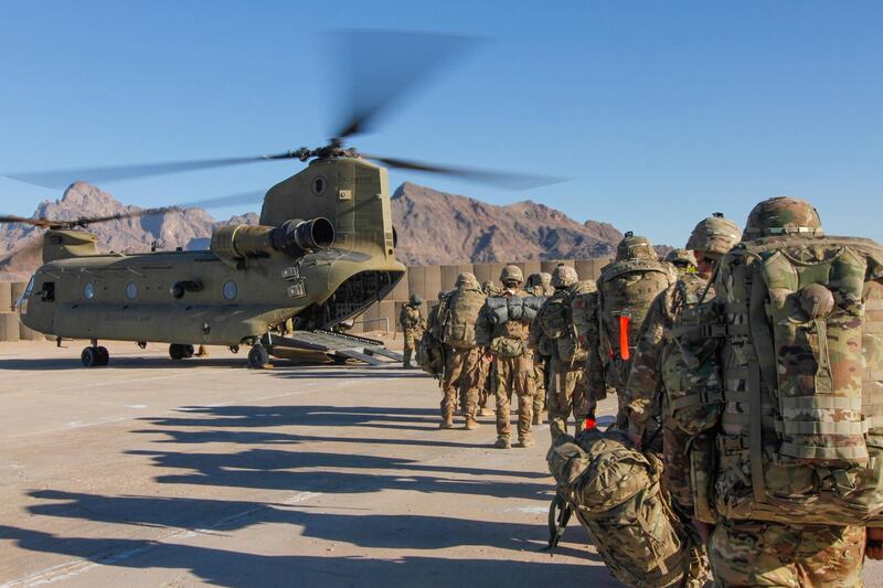 Soldiers attached to the 101st Resolute Support Sustainment Brigade, Iowa National Guard and 10th Mountain, 2-14 Infantry Battalion, load onto a Chinook helicopter to head out on a mission in Afghanistan, January 15, 2019.     1st Lt. Verniccia Ford/U.S. Army/Handout via REUTERS   ATTENTION EDITORS - THIS IMAGE WAS PROVIDED BY A THIRD PARTY.