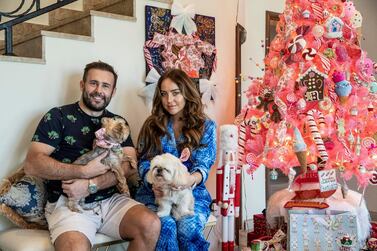  Cherry and Ben Watson pose with their two dogs and candy cane tree. Photo: Antonie Robertson/The National