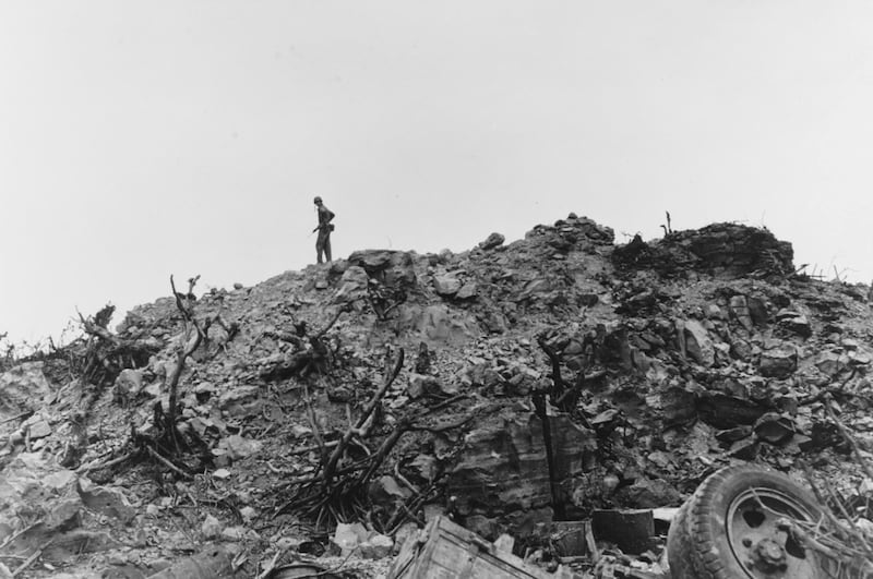 A US Marine surveys the shattered landscape while hunting for remaining Japanese forces on Iwo Jima, March 1945. US National Archives. Reuters