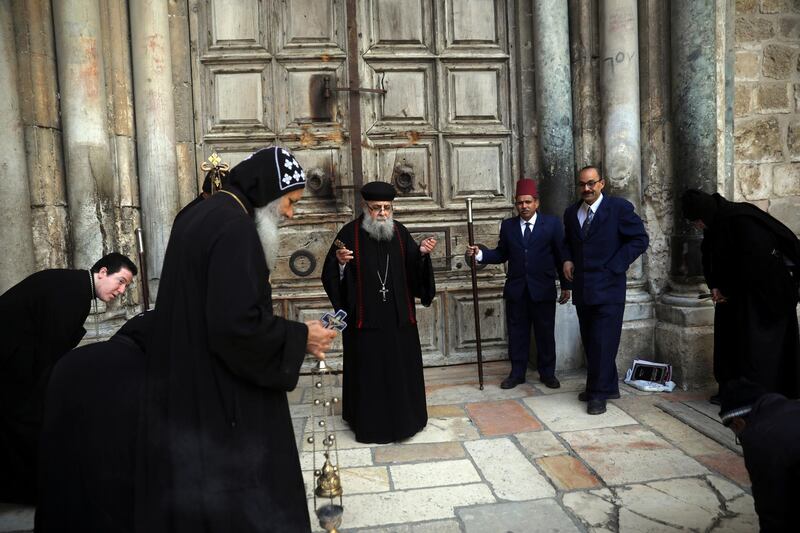 Coptic priests hold a mass outside a closed Church of the Holy Sepulchre, in Jerusalem, on March 28, 2020. AP Photo