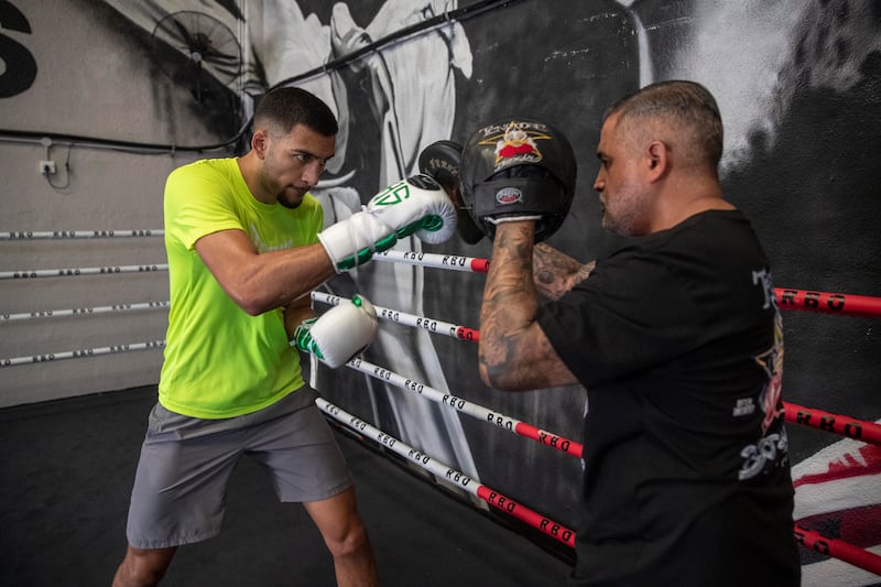 Hamzah Sheeraz hits the pads with trainer Ricky Funez at the Real Boxing Only Gym. Antonie Robertson / The National