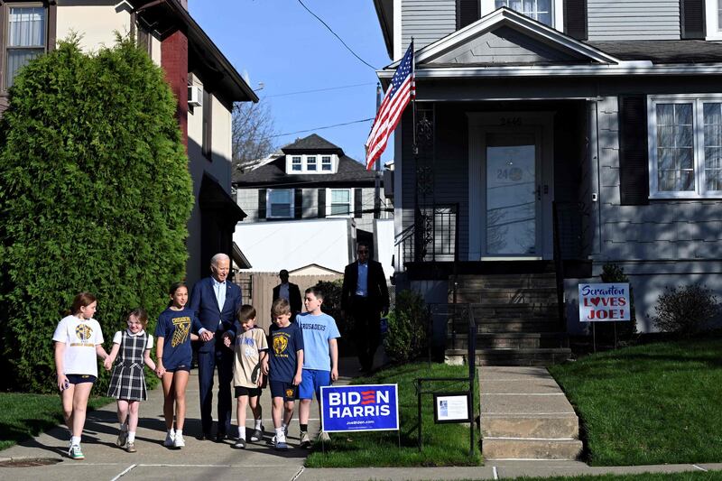 US President Joe Biden walks with children in front of his childhood home in Scranton, Pennsylvania. AFP
